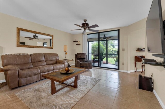 living room with ceiling fan, light tile patterned floors, and expansive windows