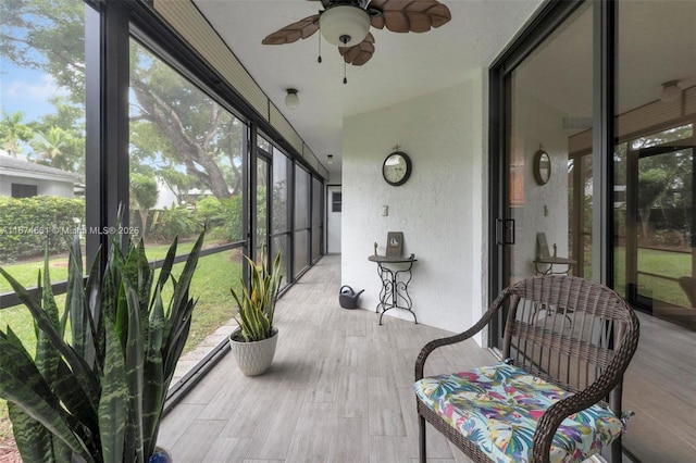 sunroom with ceiling fan and a wealth of natural light