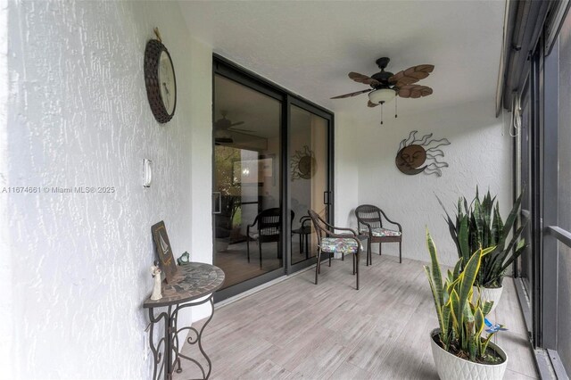 sunroom featuring ceiling fan