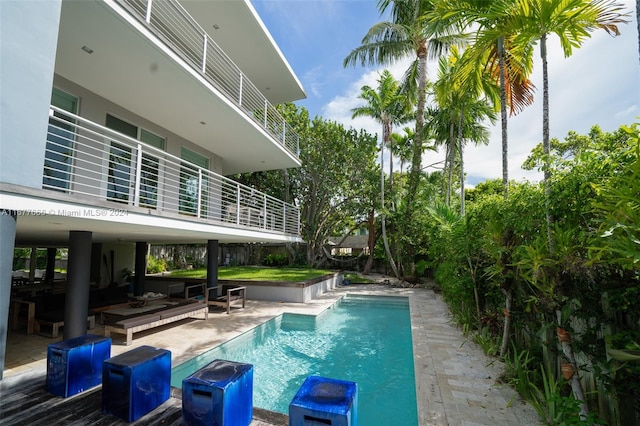 view of pool with a patio and an outdoor living space