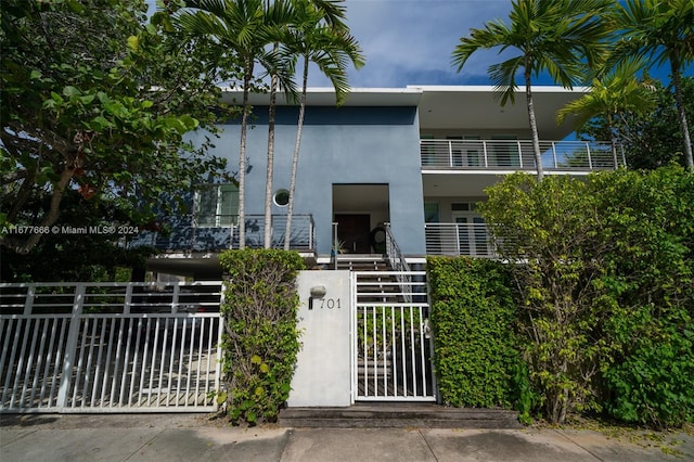 view of front of house with a balcony