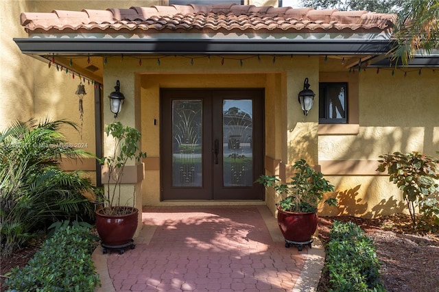 property entrance with a patio area and french doors