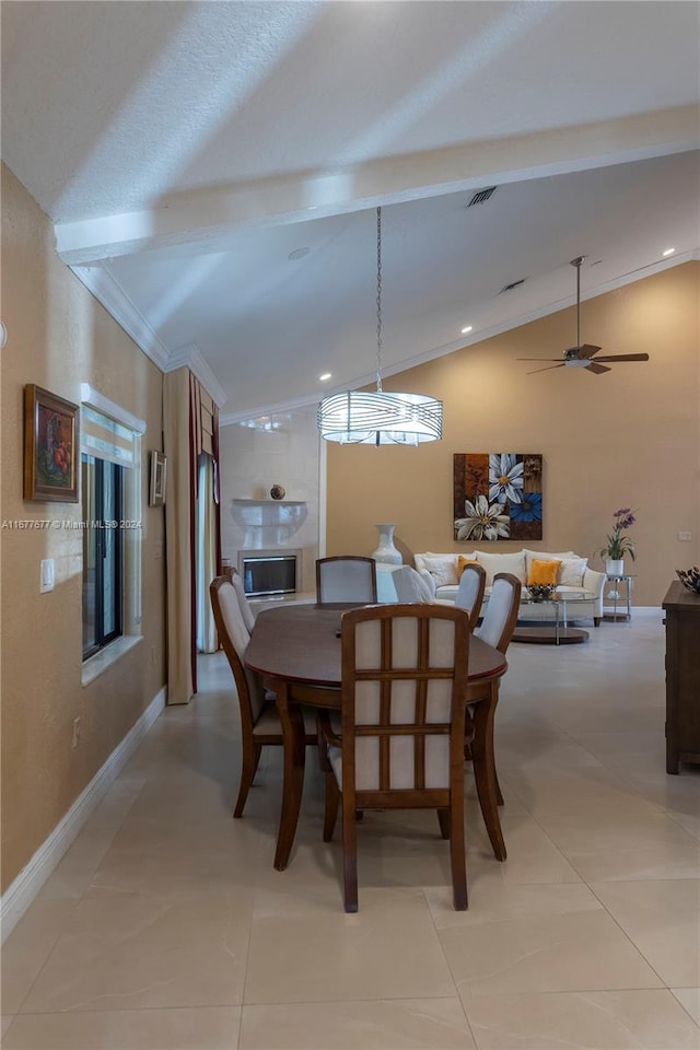 tiled dining area with crown molding, ceiling fan, and lofted ceiling