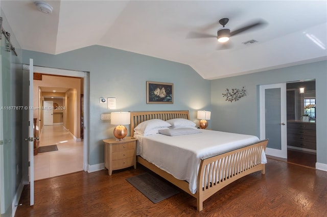 bedroom featuring ceiling fan, dark wood-type flooring, and vaulted ceiling