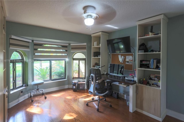 office featuring wood-type flooring, a textured ceiling, and ceiling fan