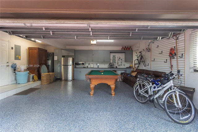 garage with electric panel and stainless steel refrigerator