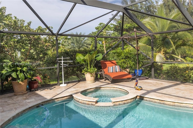 view of swimming pool featuring glass enclosure, an in ground hot tub, and a patio