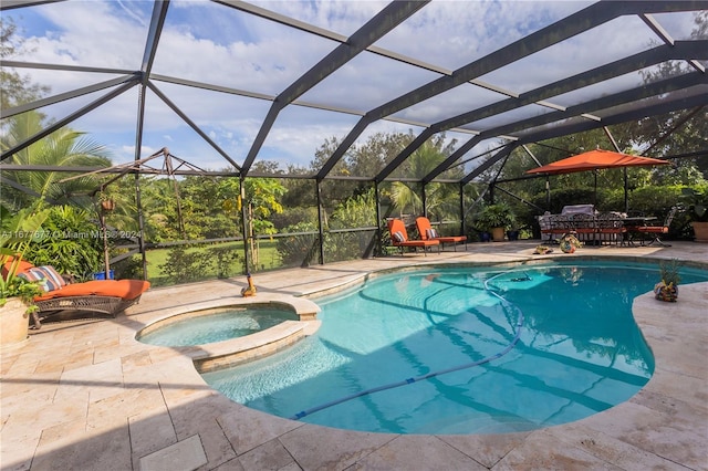 view of pool with a lanai, a patio area, and an in ground hot tub