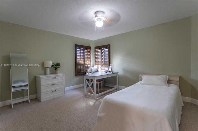 bedroom with ceiling fan and a textured ceiling