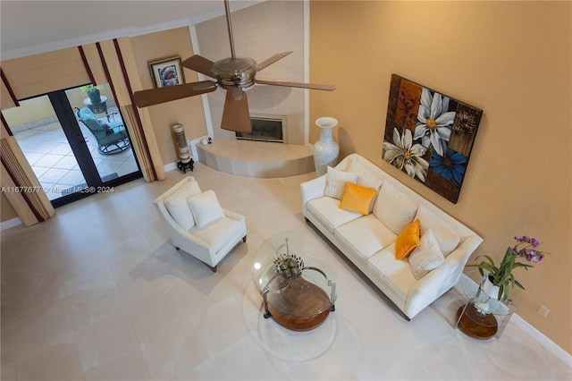 living room with ceiling fan and ornamental molding