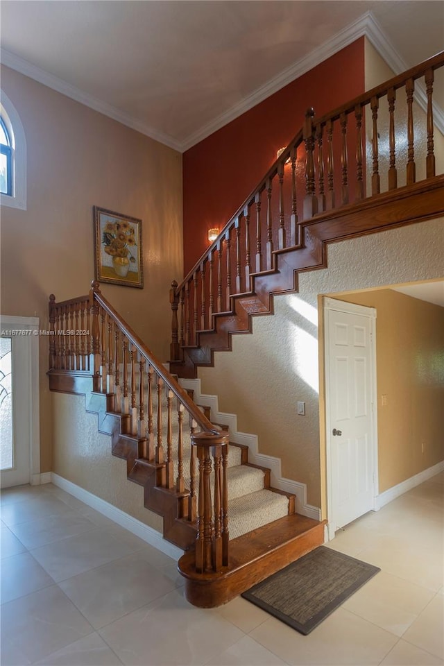 staircase featuring tile patterned flooring and crown molding