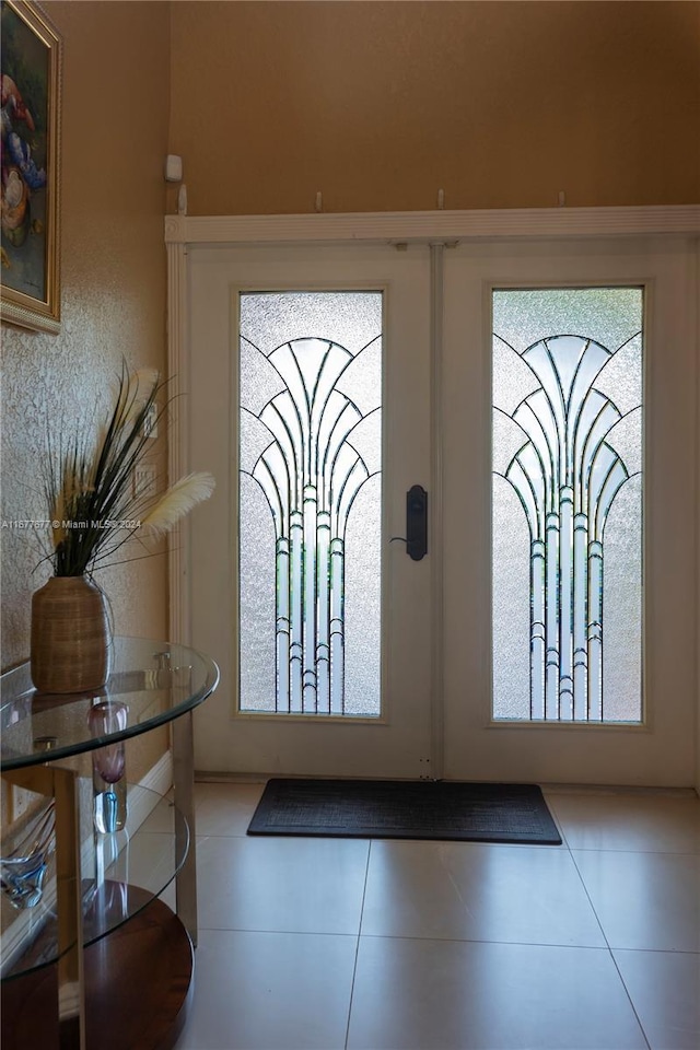 entryway featuring tile patterned flooring and french doors