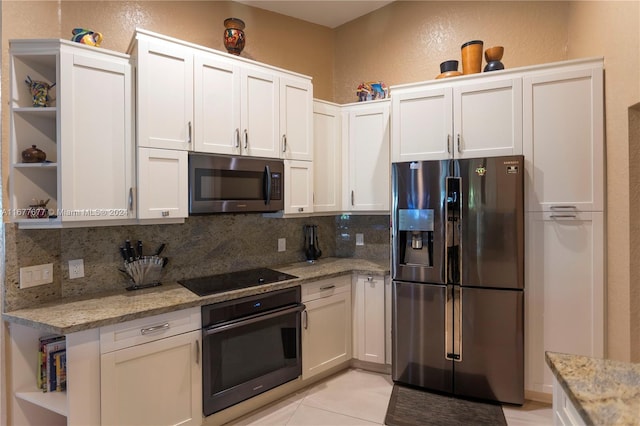 kitchen with white cabinetry, light stone countertops, and appliances with stainless steel finishes