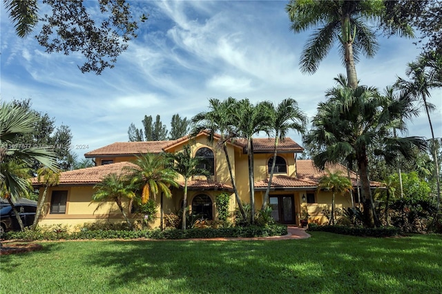 mediterranean / spanish-style home with a front lawn