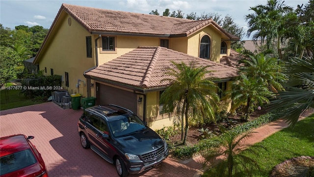 mediterranean / spanish home featuring a garage