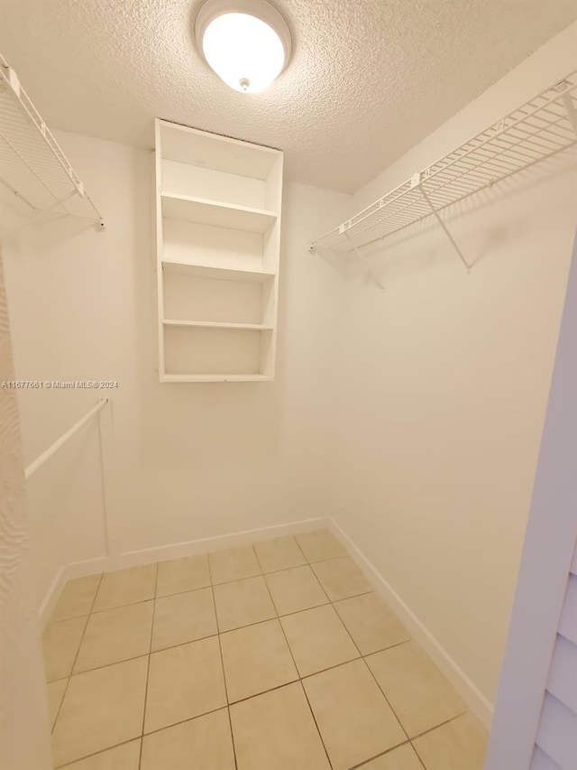 spacious closet featuring tile patterned floors