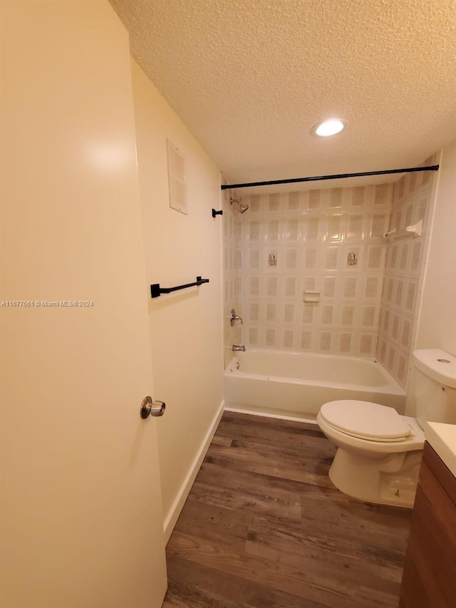 full bathroom featuring vanity, hardwood / wood-style floors, toilet, and tub / shower combination