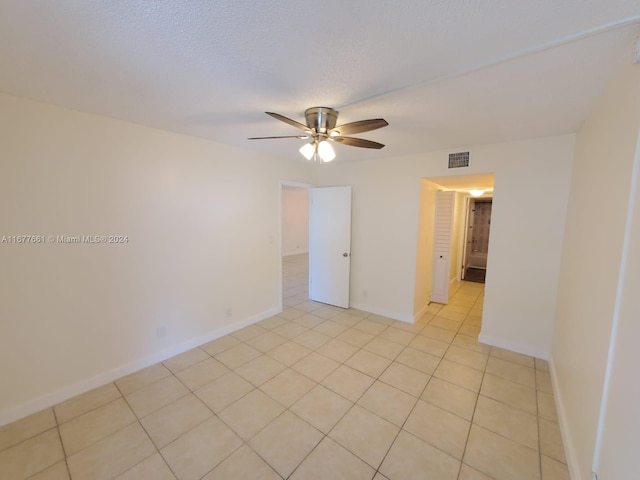 unfurnished room featuring light tile patterned floors and ceiling fan