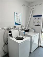 washroom with washing machine and clothes dryer