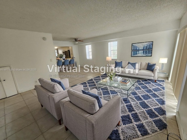 tiled living room with ceiling fan and a textured ceiling