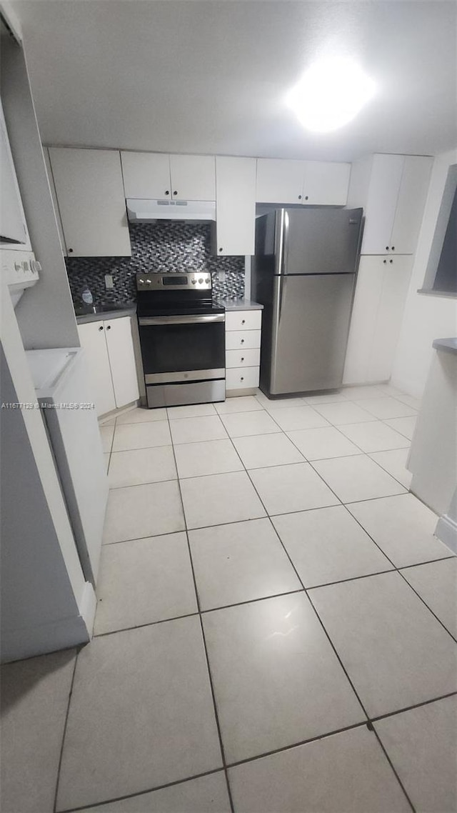 kitchen with white cabinetry, tasteful backsplash, appliances with stainless steel finishes, and light tile patterned floors