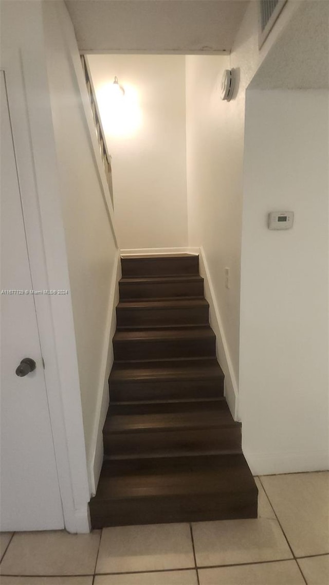 stairway featuring tile patterned floors