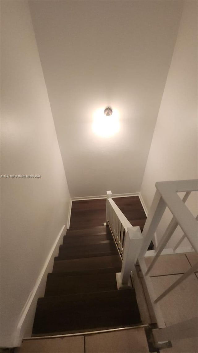 stairs with hardwood / wood-style floors