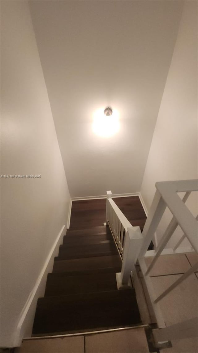 stairway with hardwood / wood-style floors