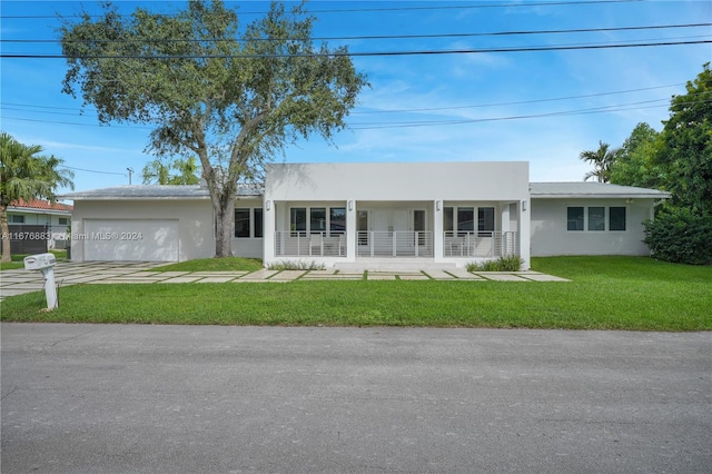 single story home featuring a front yard and a garage