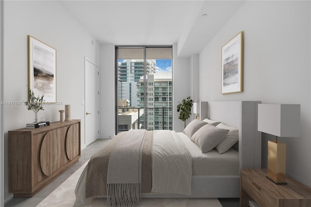 bedroom with a wall of windows and access to exterior