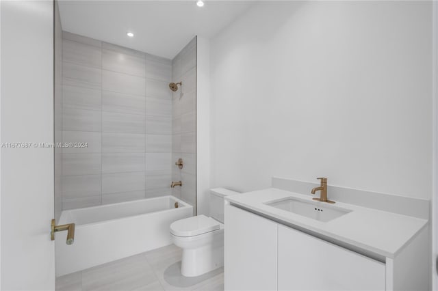 full bathroom featuring vanity, toilet, tile patterned floors, and tiled shower / bath