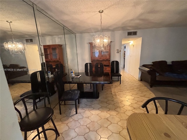 5300 Washington St Unit U103, Hollywood, FL 33021 - dining space with a textured ceiling, visible vents, and a notable chandelier