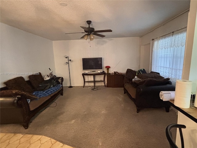 living room with ceiling fan, a textured ceiling, and carpet floors