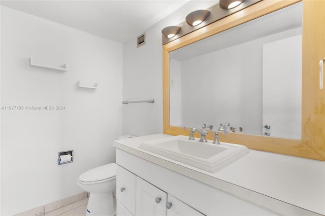 bathroom featuring vanity, toilet, and tile patterned flooring