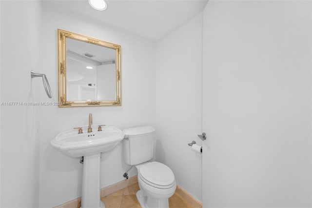 bathroom with tile patterned floors, sink, and toilet