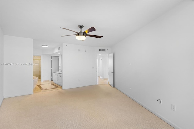 unfurnished room featuring ceiling fan and light carpet