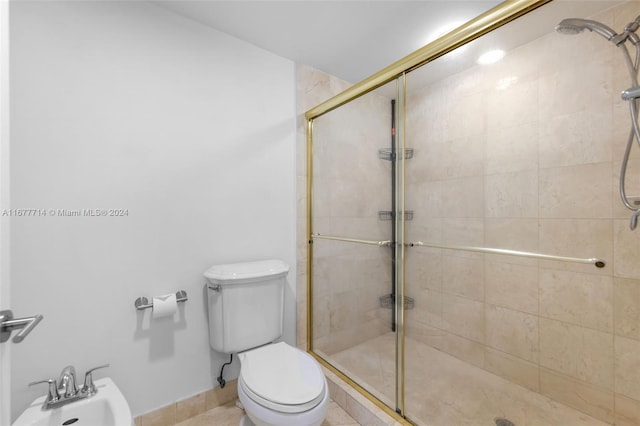 bathroom featuring tile patterned floors, a bidet, an enclosed shower, and toilet