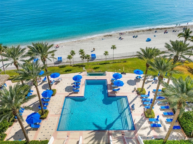 view of swimming pool with a view of the beach and a water view