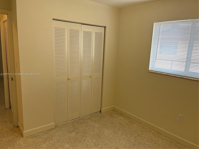 unfurnished bedroom with a closet