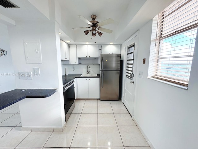 kitchen featuring white cabinets, appliances with stainless steel finishes, and a healthy amount of sunlight