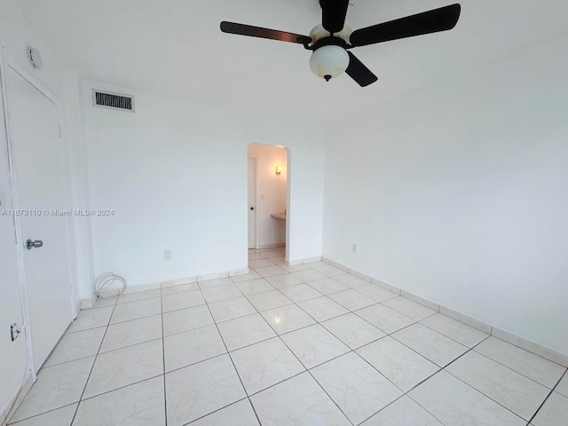 unfurnished room featuring light tile patterned flooring and ceiling fan