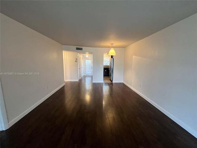 unfurnished living room with dark wood-type flooring