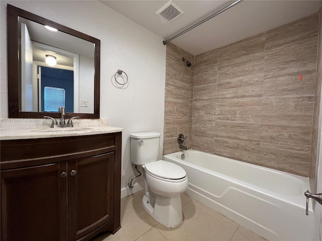 full bathroom featuring vanity, tiled shower / bath, toilet, and tile patterned flooring