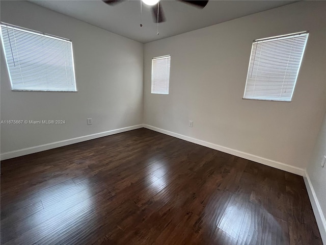 unfurnished room with dark wood-type flooring and ceiling fan