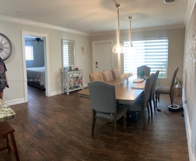 dining space with dark wood-type flooring, ceiling fan, and ornamental molding