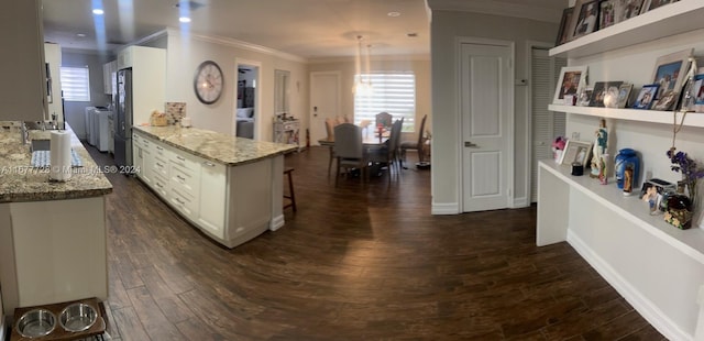 kitchen with white cabinetry, dark hardwood / wood-style flooring, and fridge