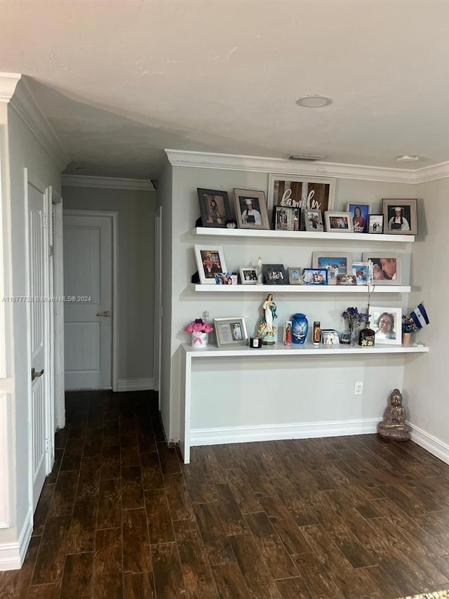 interior space with ornamental molding and wood-type flooring