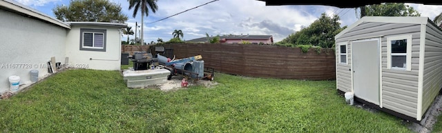 view of yard featuring a storage unit