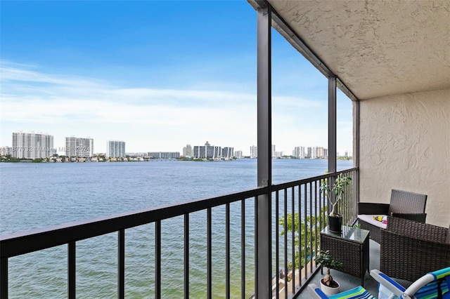 sunroom / solarium featuring a water view