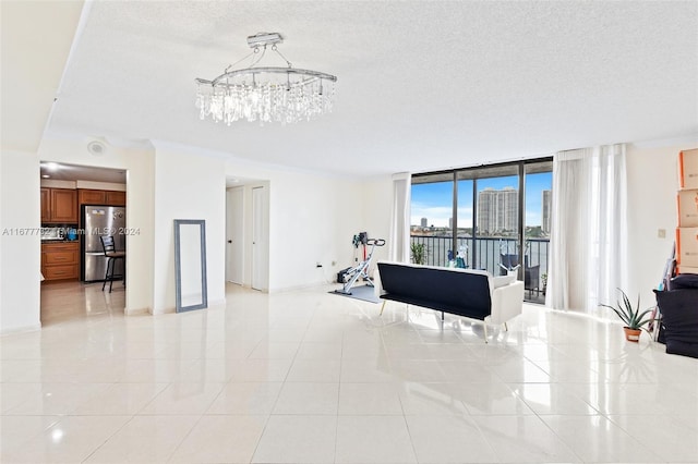 tiled living room with a notable chandelier, a wall of windows, ornamental molding, and a textured ceiling